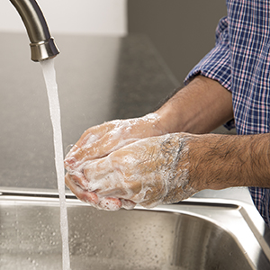 Closeup of hands washing with soap and water.